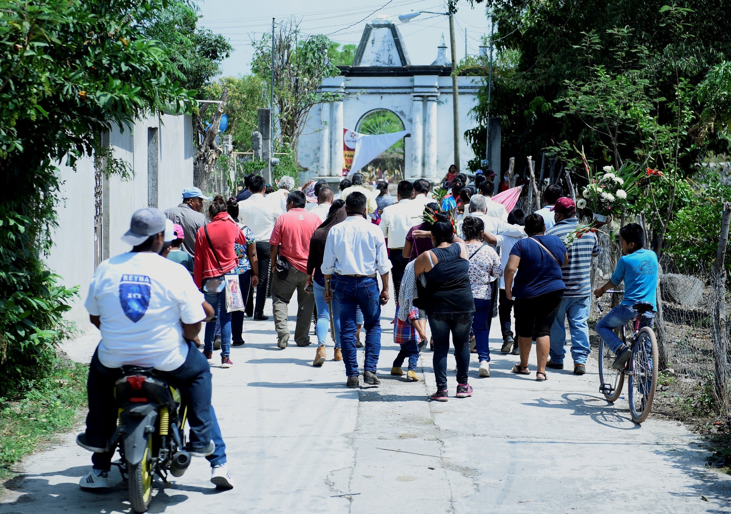 Members of the indigenous Telixtac community move the remains of a person who died after drinking allegedly adulterated alcohol in Morelos, Mexico