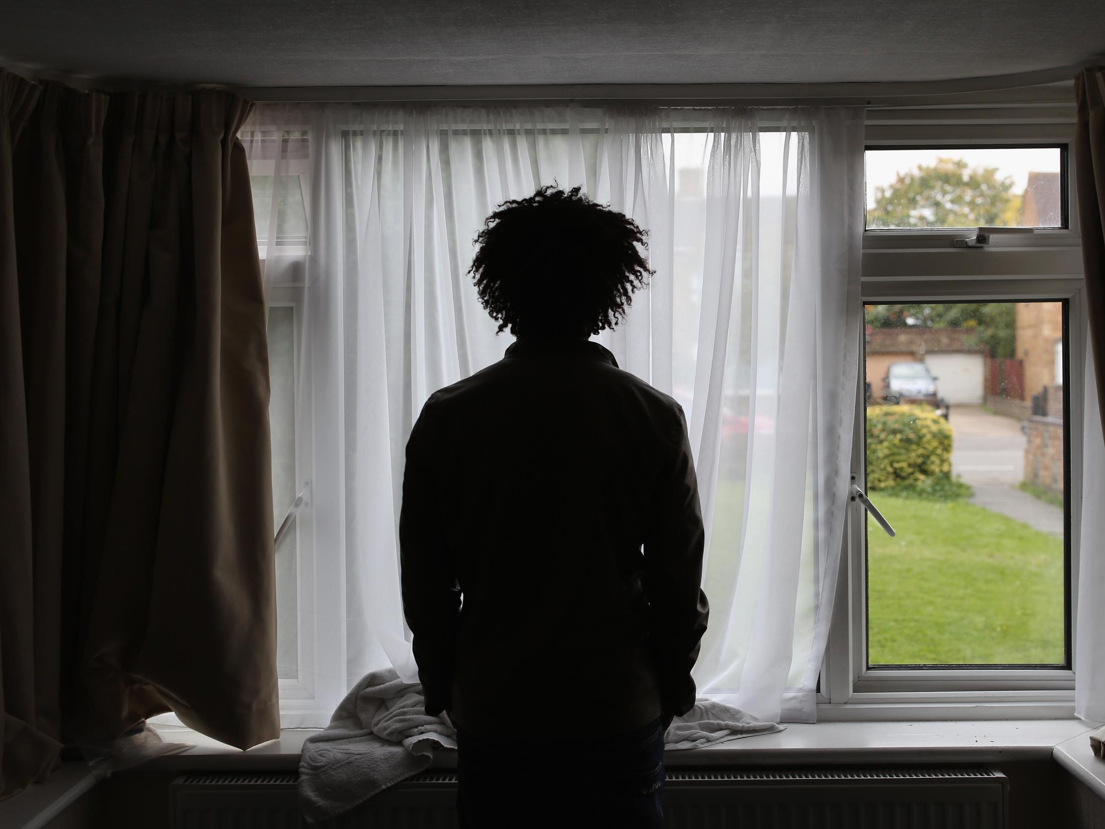 Asylum seeker, Merhawi, from Eritrea, stands inside his single room accommodation in Longford, England 2015