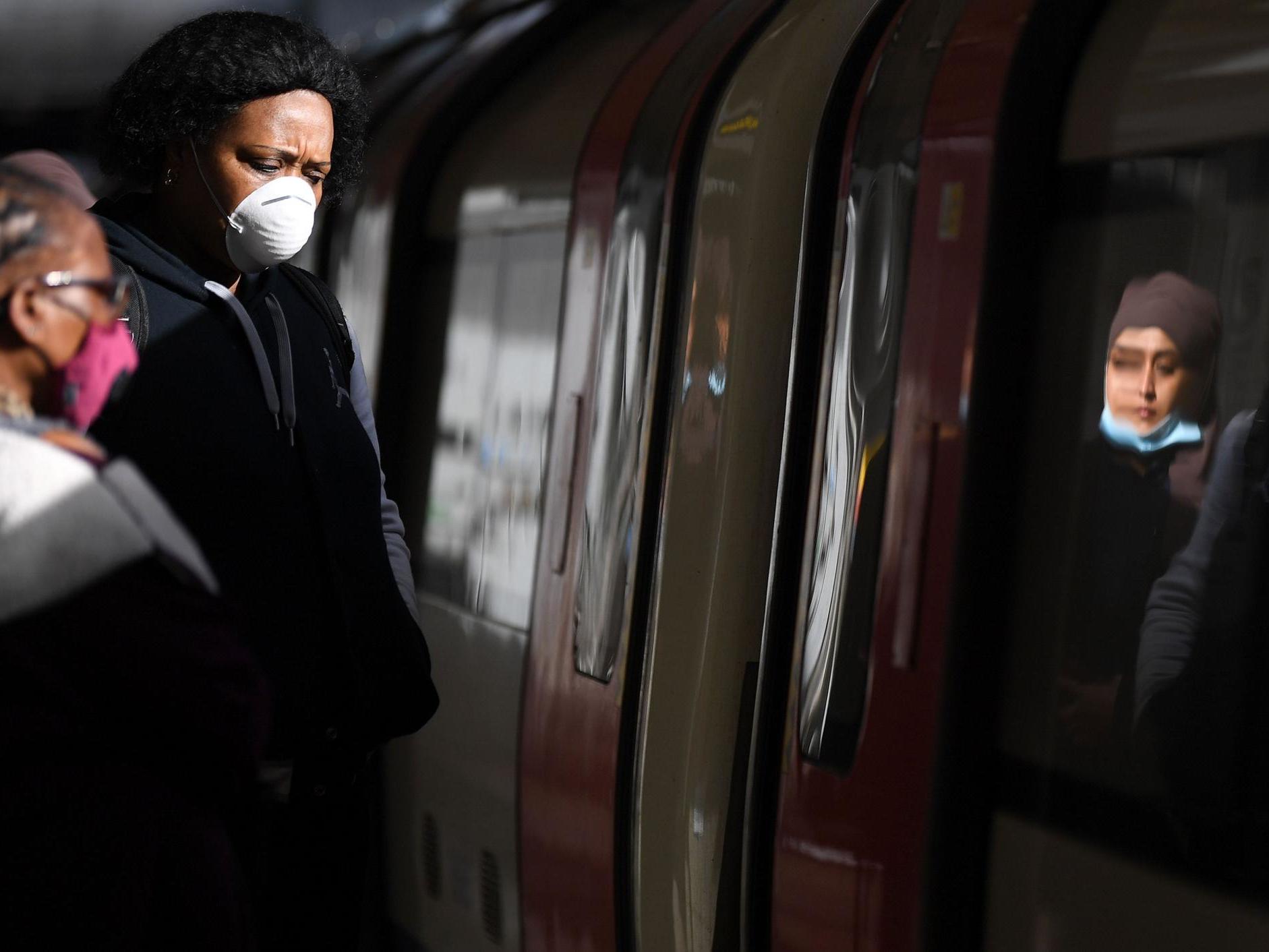 Commuters wearing PPE while travelling during London rush hour, 13 March 2020