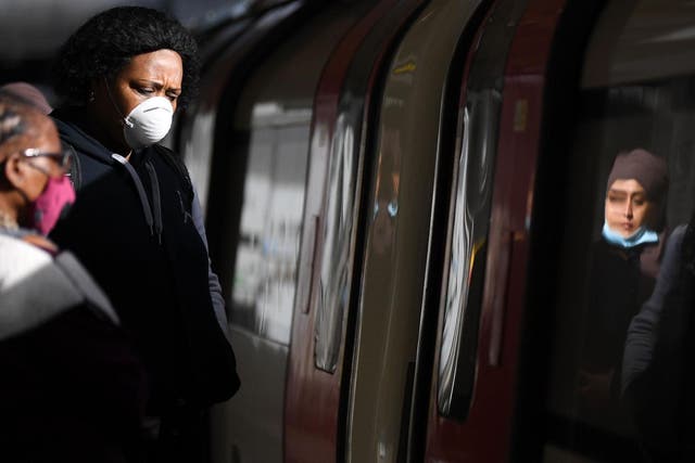 Commuters wearing PPE while travelling during London rush hour, 13 March 2020