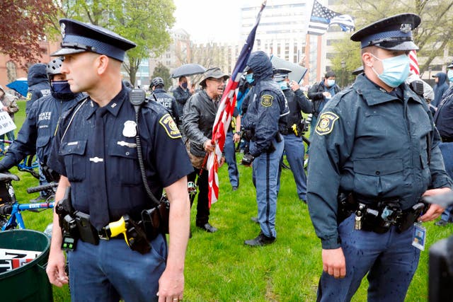 Police patrol a demonstration by people protesting against coronavirus lockdown measures in Lansing, Michigan