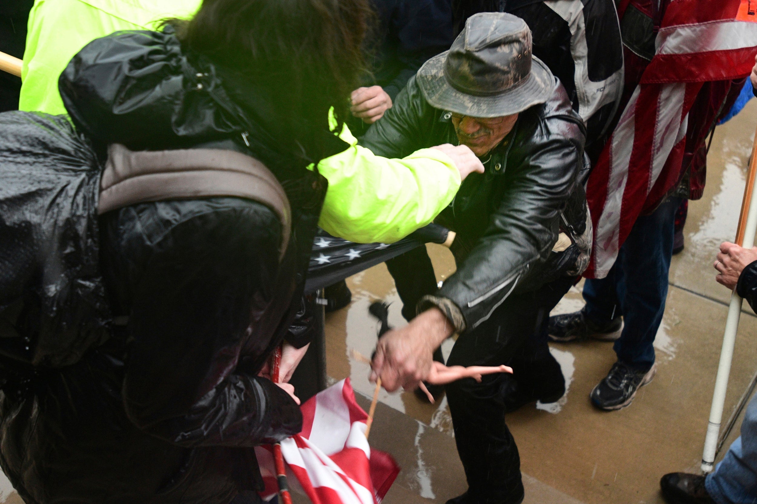 A scuffle breaks out among protesters during a rally against lockdown measures in Lansing, Michigan