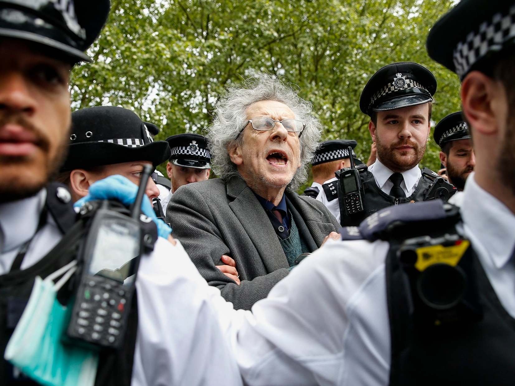 Police officers apprehend Piers Corbyn, Jeremy Corbyn’s brother, during a demonstration against the coronavirus lockdown in Hyde Park on 16 May (Hollie Adams/Getty Images)