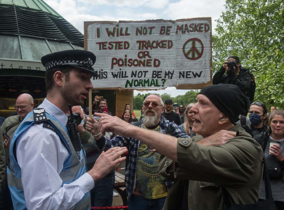 Police speak to a protester as conspiracy theorists gather at Hyde Park Corner on 16 May 2020 in London