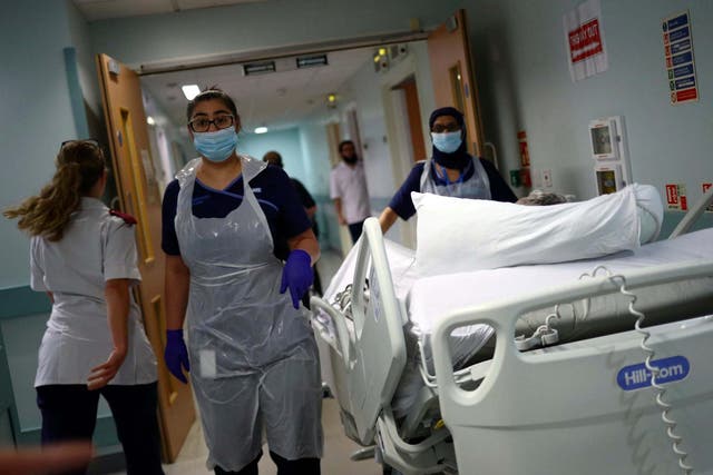 Medical staff transfer a patient through a corridor at the Royal Blackburn Teaching Hospital, in Blackburn, England