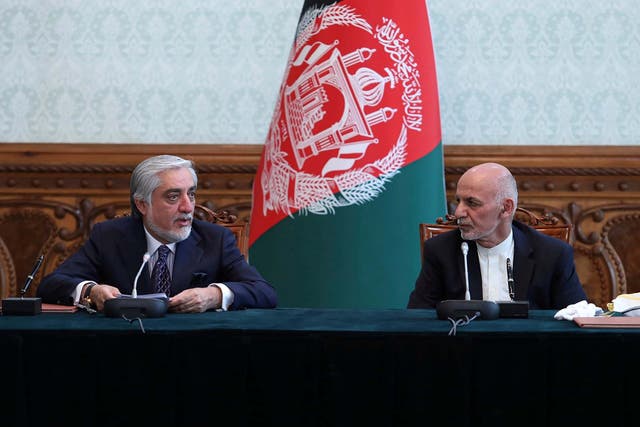 Afghan president Ashraf Ghani, right, and political rival Abdullah Abdullah speak after they signed a power-sharing agreement at the presidential palace in Kabul