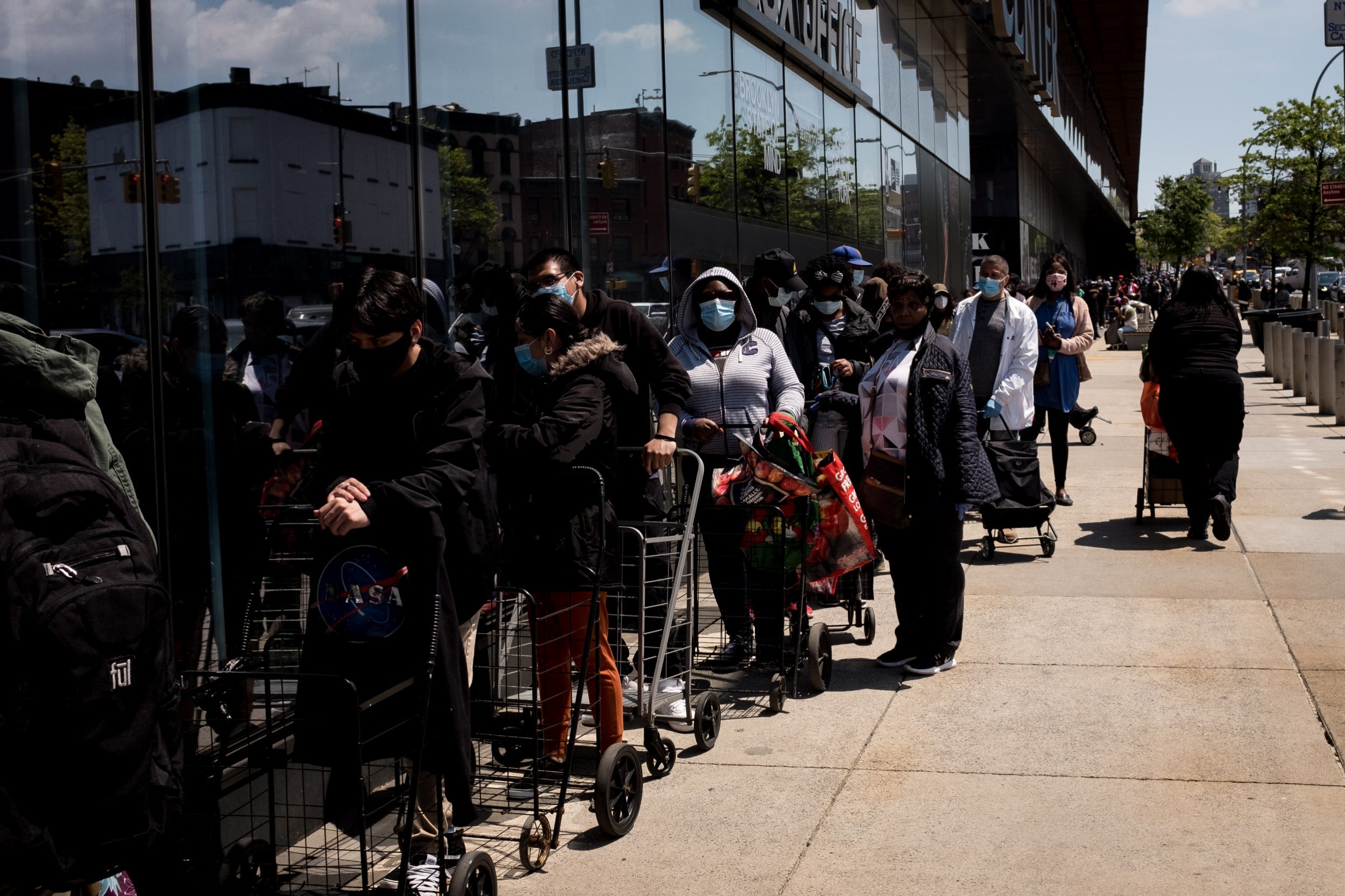 People facing financial stress waiting for food donations in Brooklyn