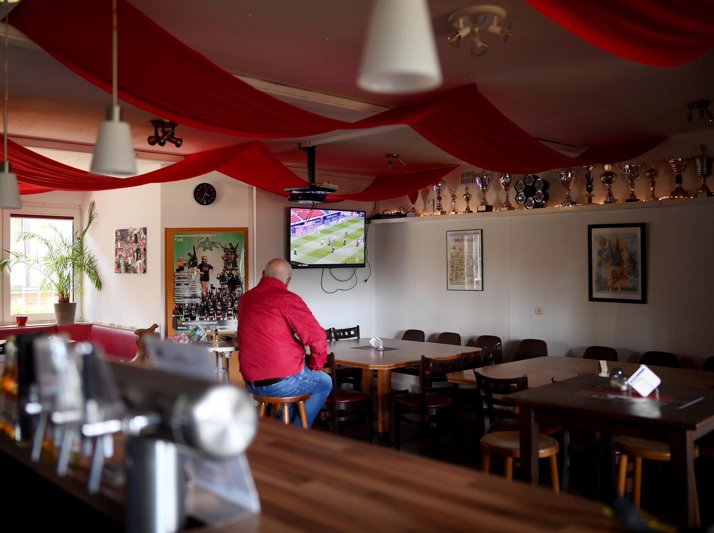 German fan watches the Bundesliga in an empty bar