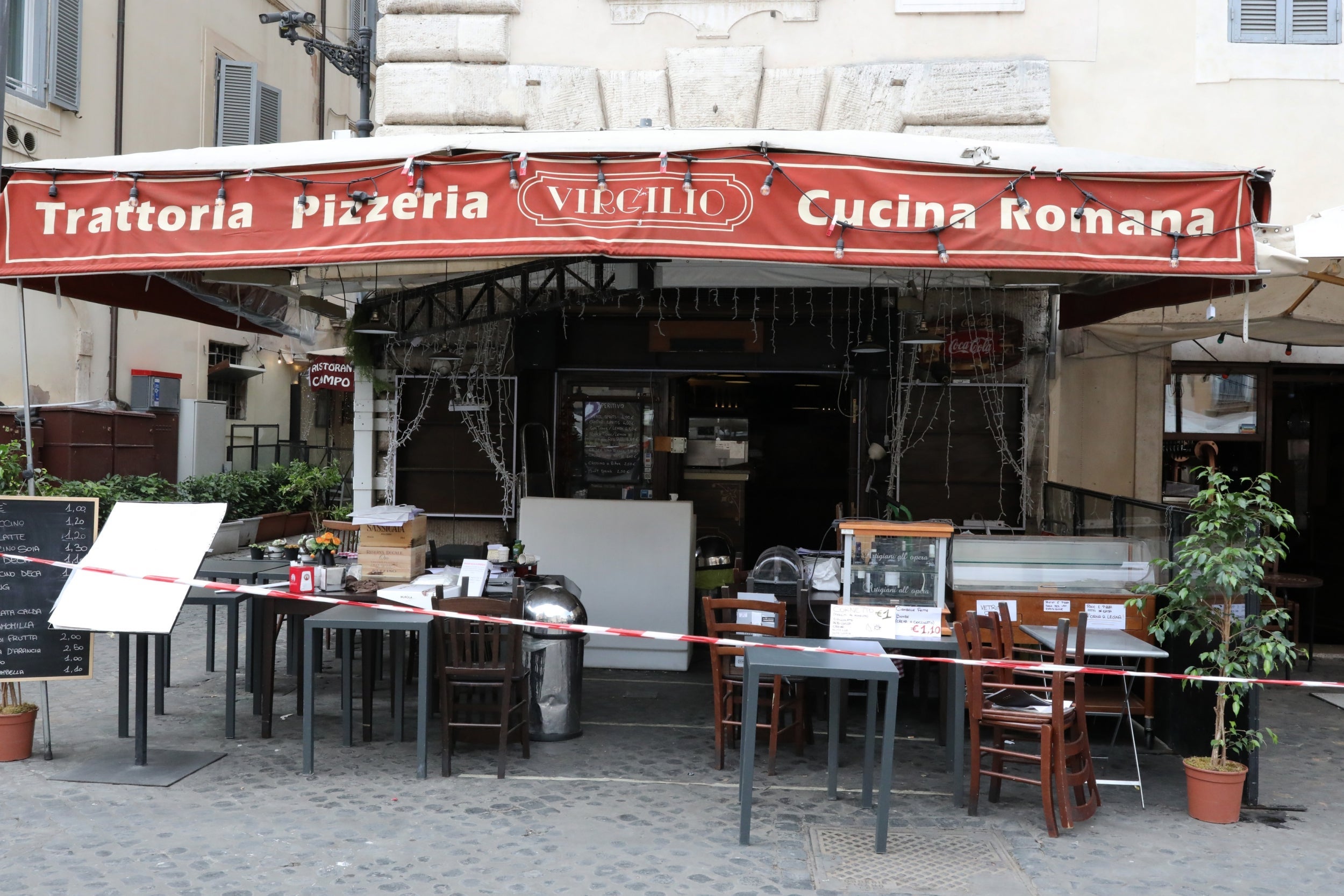 Stacked tables and chairs of a restaurant in Rome that did not reorganise in time to reopen at the lifting of the lockdown