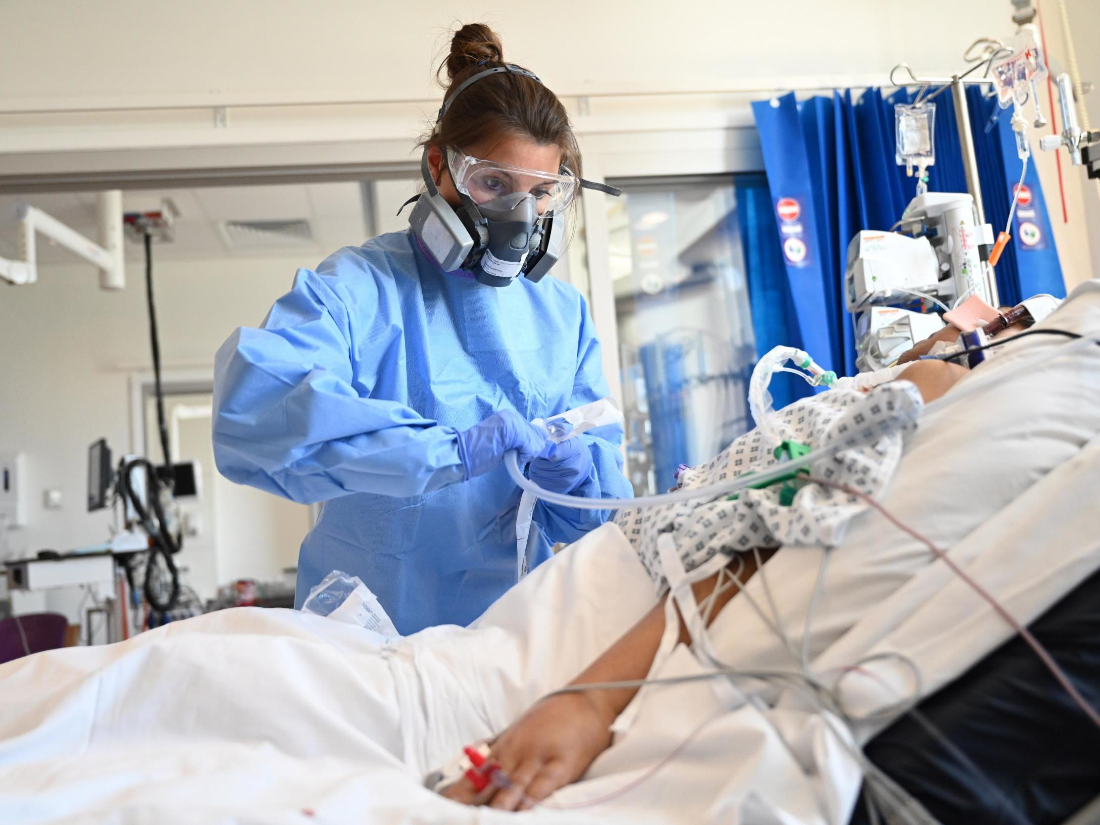 Clinical staff wear Personal Protective Equipment (PPE) as they care for a patient at the Intensive Care Unit at Royal Papworth Hospital on May 5, 2020 in Cambridge, England.