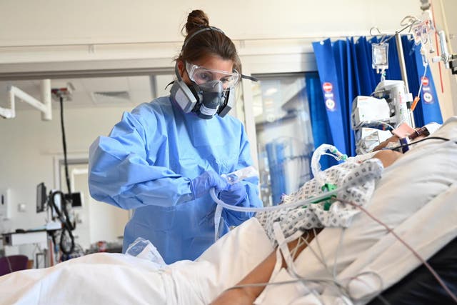 Clinical staff wear Personal Protective Equipment (PPE) as they care for a patient at the Intensive Care Unit at Royal Papworth Hospital on May 5, 2020 in Cambridge, England.