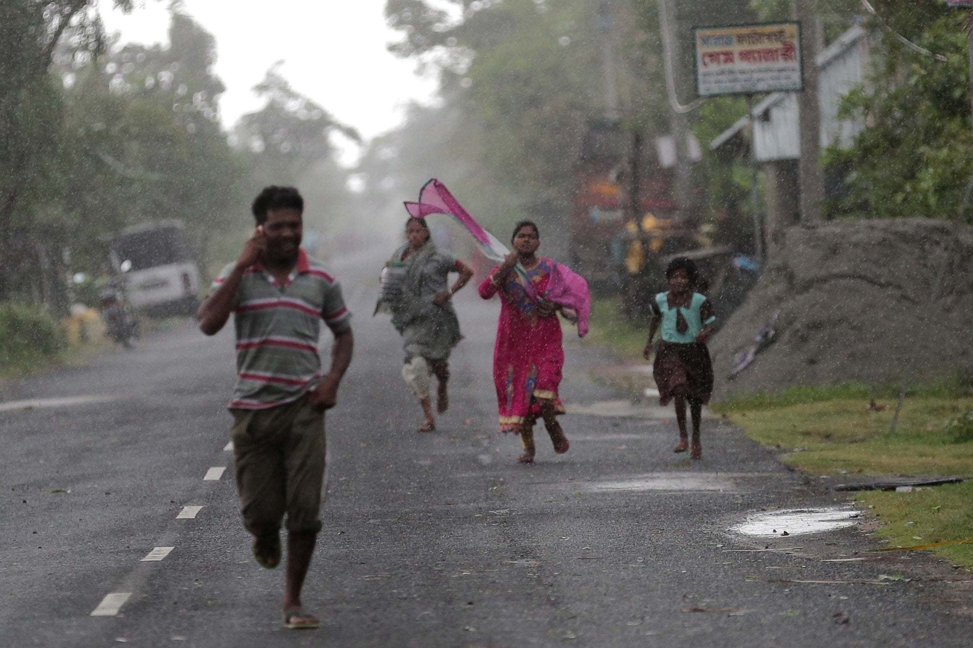 Villagers run for cover as they evacuate the storm near the Bay of Bengal