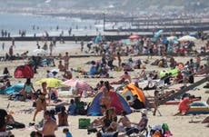 Crowds hit UK beaches amid lockdown as Met Office confirms hottest day
