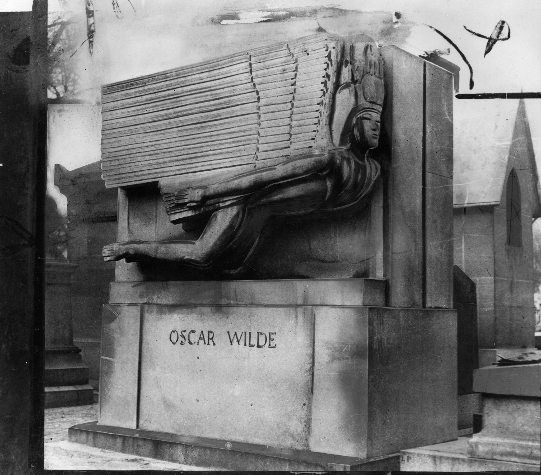 Wilde’s tomb in Pere Lachaise cemetery in Paris, created by sculptor Jacob Epstein and featuring a plinth by Charles Holden and an inscription carved by Joseph Cribb