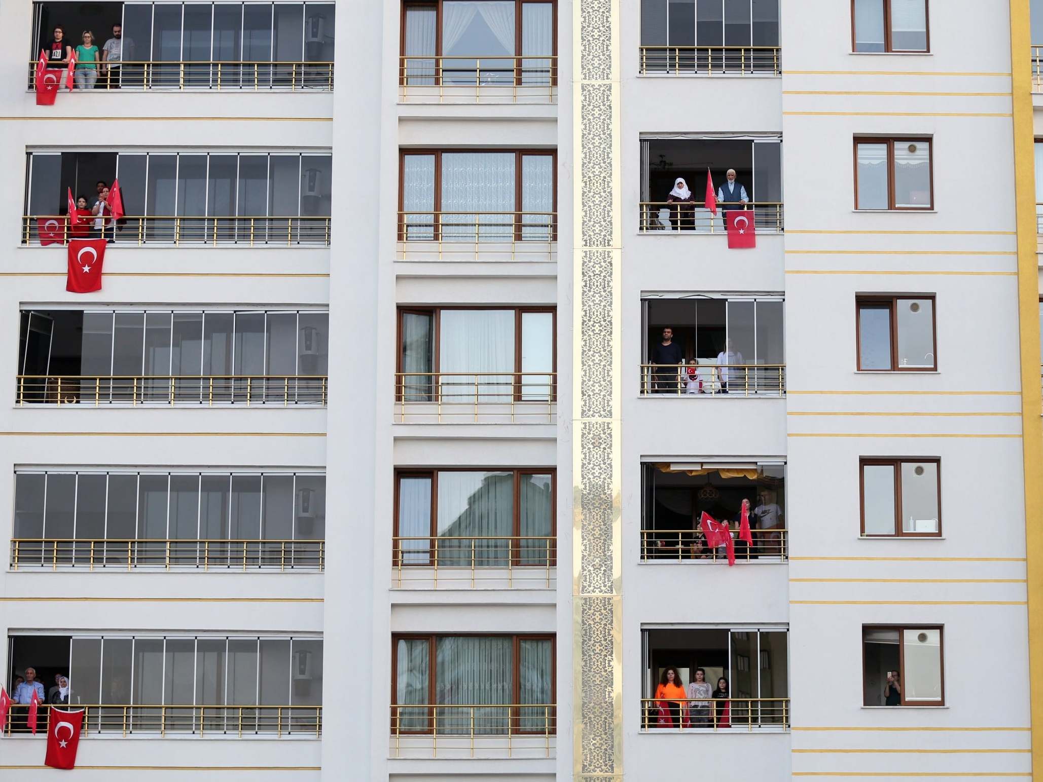 A man has been detained for hanging a towel with a UK flag from a balcony while others display Turkish flags during a national holiday