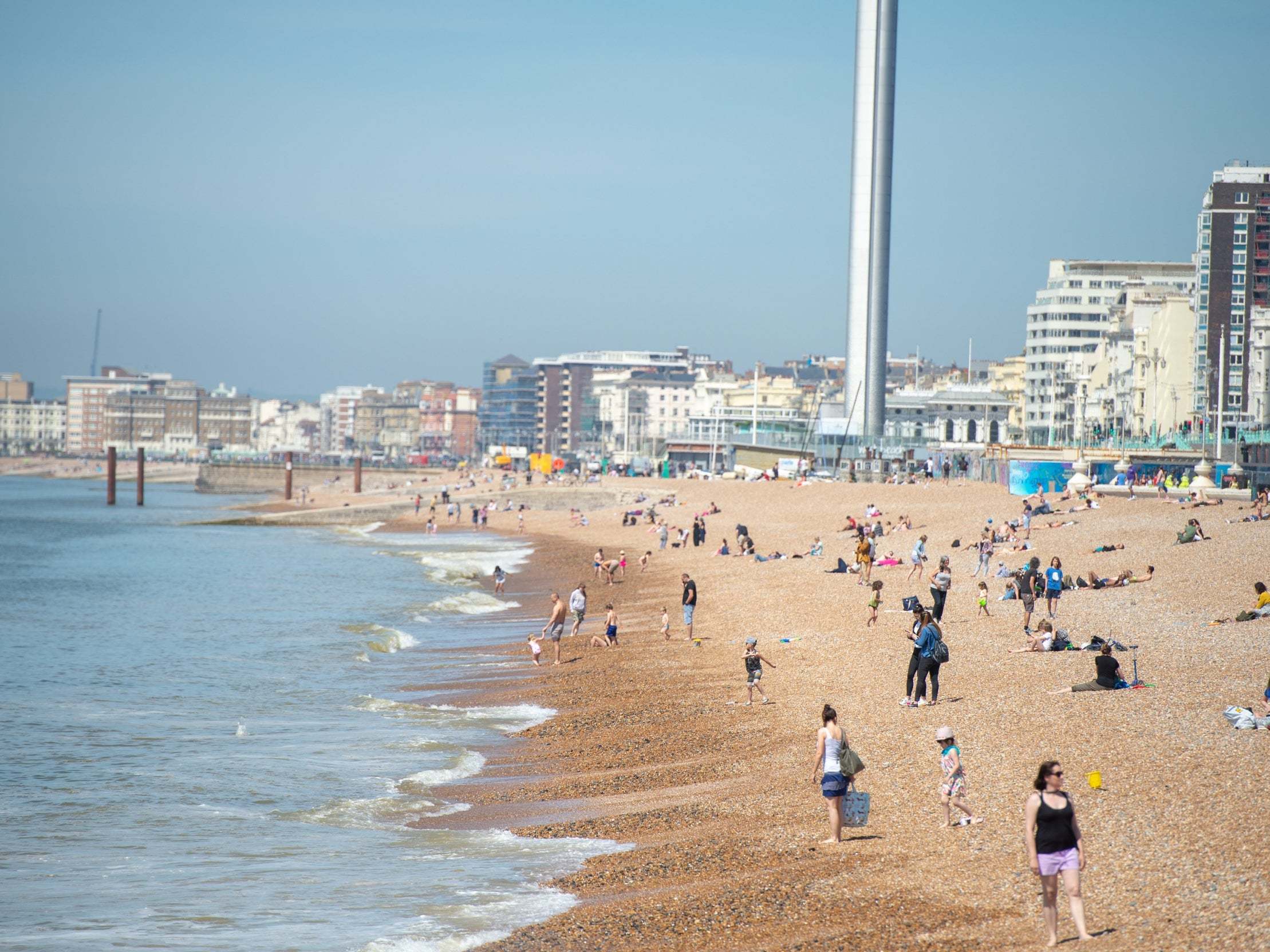 People enjoying warm weather on Brighton Beach