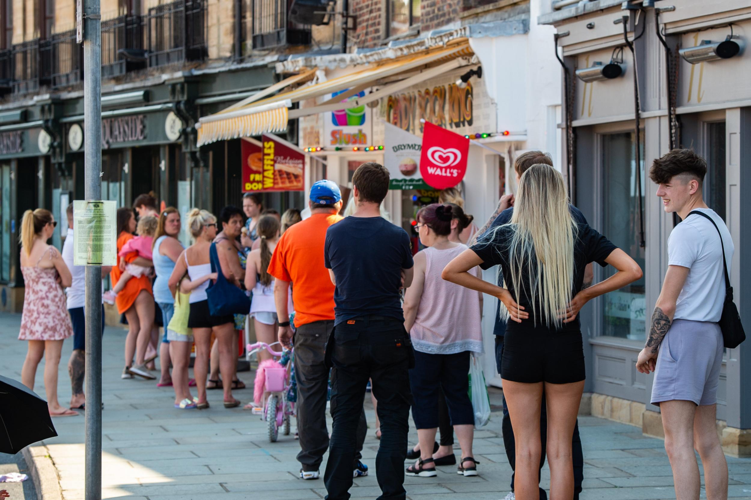 People try to observe 2-metre social distancing rules as they queue for ice-creams in Whitby (SWNS )