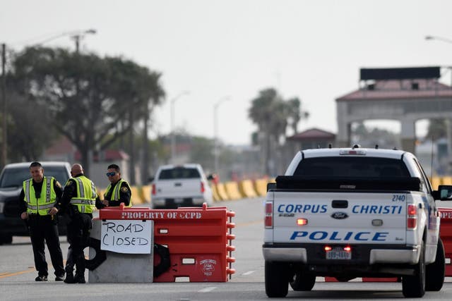 Police officers stand at a checkpoint after a shooting incident at Naval Air Station Corpus Christi, Texas