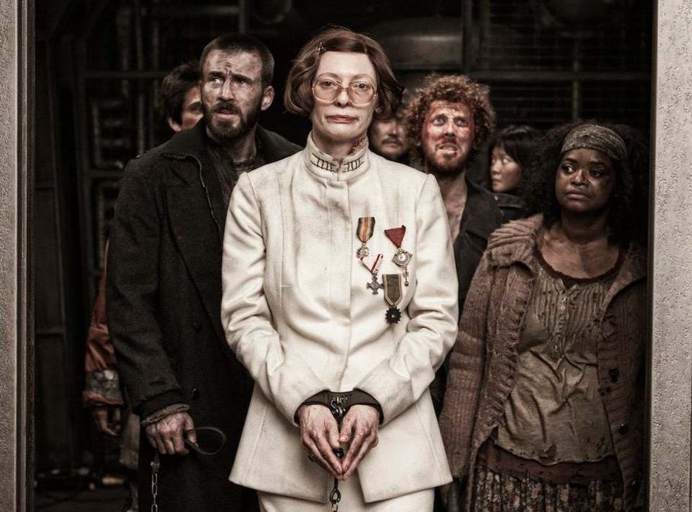 Tilda Swinton stars as Minister Mason – a ghastly caricature of the human form, with her piggy nose, prominent teeth, itchy wig, and fake war medals