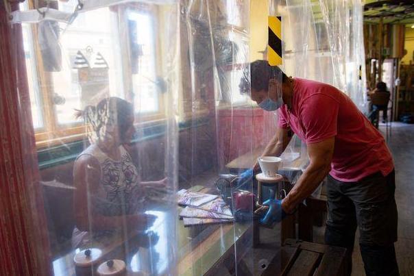 Coronavirus: Cafe hangs shower curtains to protect customers from coronavirus in hope of reopening