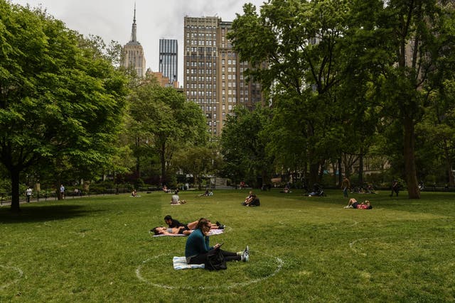 Social distancing methods such as painted circles in parks are just some of the ways US states are scrambling to flatten the coronavirus curve