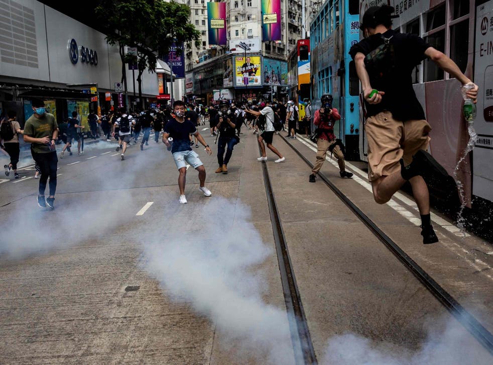 Police fire tear gas on protesters during a planned protests against a proposal to enact a new security legislation in Hong Kong