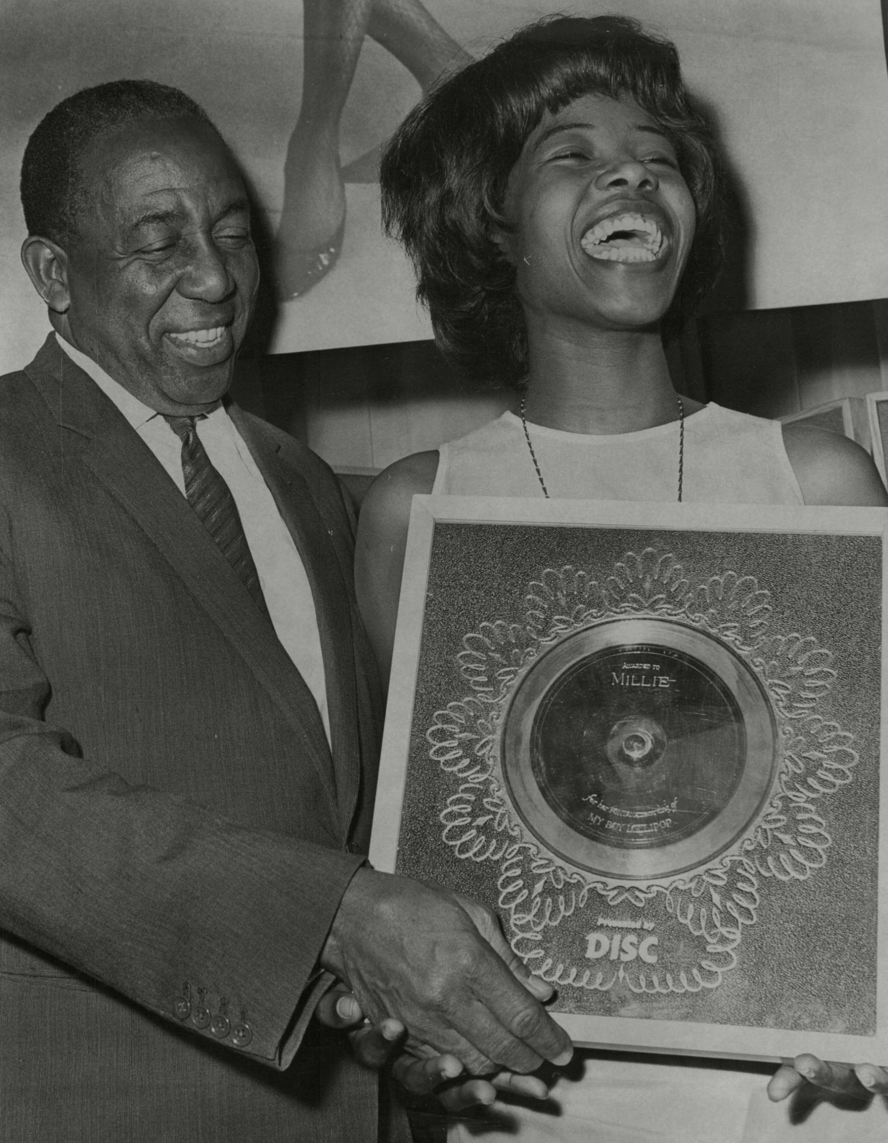 The singer receiving a Silver Disc from cricketer Sir Learie Constantine for ‘My Boy Lollipop’
