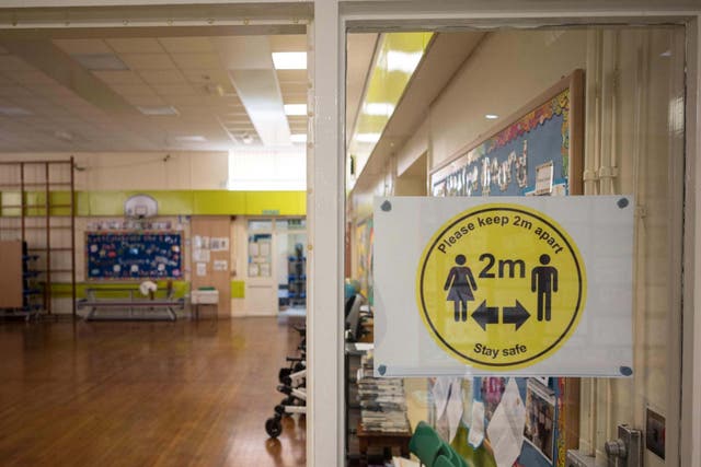 Notices advising staff and pupils to maintain 2m of separation to create an environment safe from Coronavirus are displayed at Slaithwaite C of E Junior and Infant School in Slaithwaite, near Huddersfield