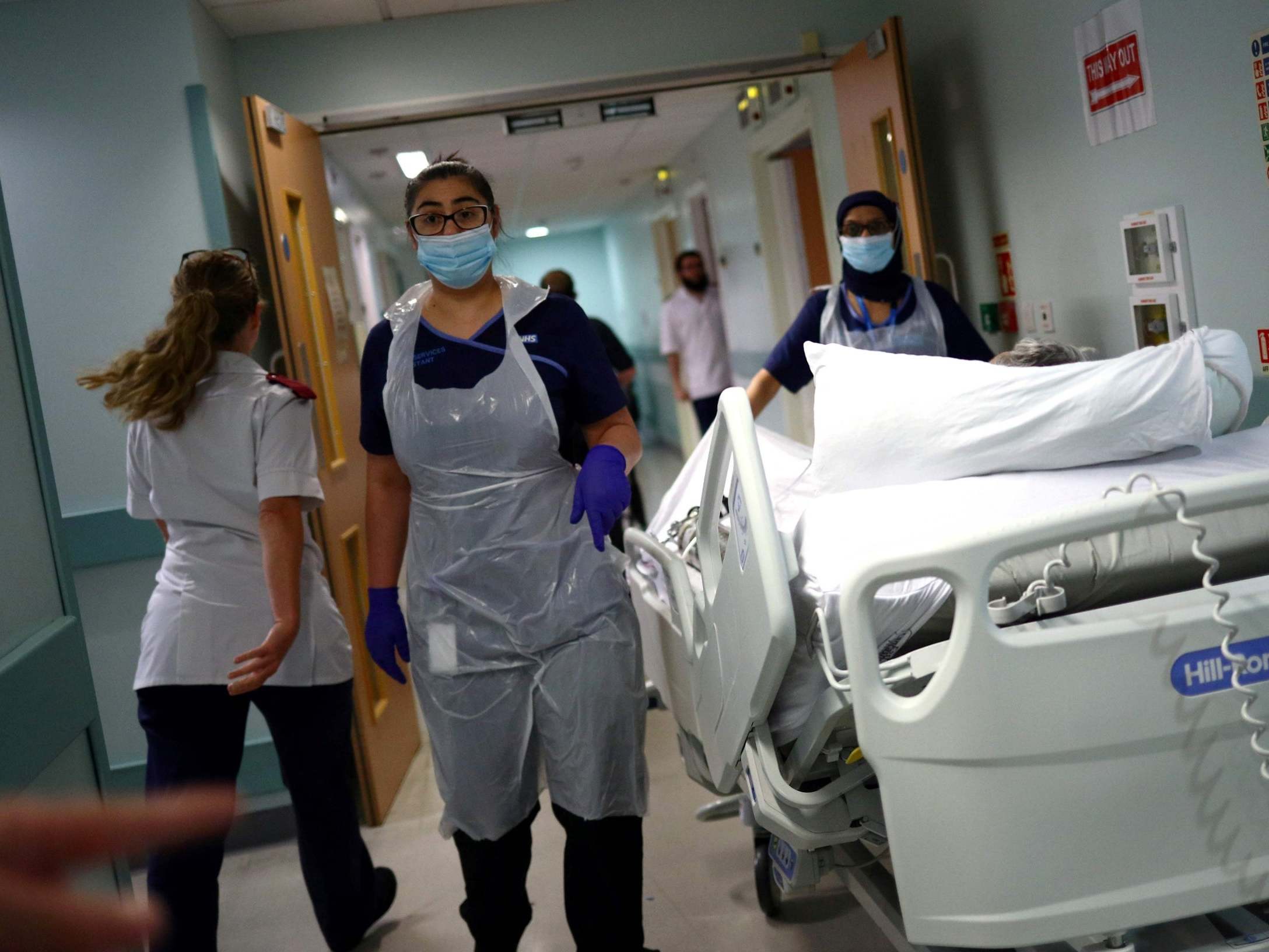 Medical staff transfer a patient along a corridor at the Royal Blackburn Teaching Hospital in Blackburn, north-west England on May 14, 2020