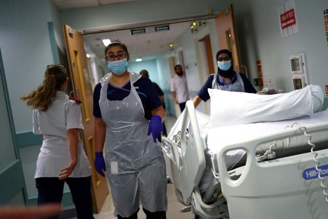 Medical staff transfer a patient along a corridor at the Royal Blackburn Teaching Hospital in Blackburn, north-west England on May 14, 2020