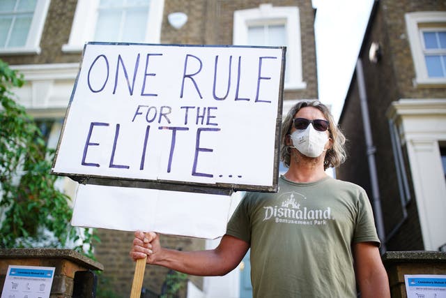 A protester outside Dominic Cummings' North London home