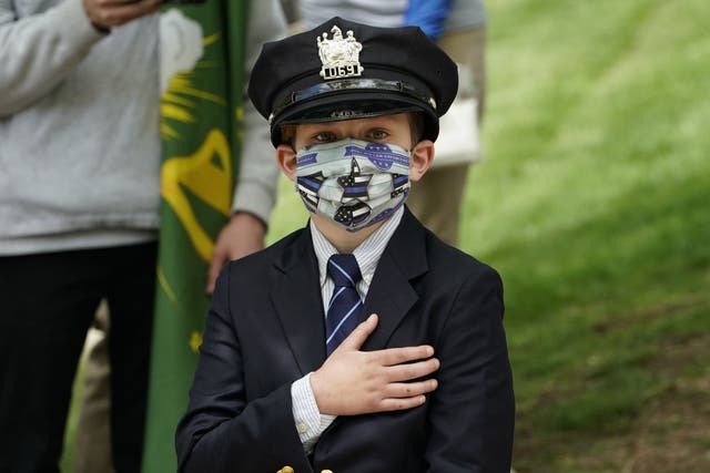 Gavin Roberts, 10, son of police officer Charles Rob Roberts, looks on during the funeral service of his father, who died of coronavirus weeks after contracting the disease while on duty, in Glen Ridge, New Jersey on May 14, 2020