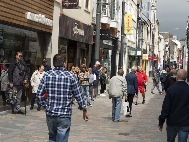 People shop in the high street as non-essential retail shops reopen in Douglas, Isle of Man, which began lifting Covid-19 lockdown restrictions on 24 April.