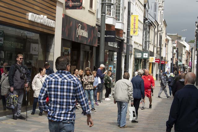 People shop in the high street as non-essential retail shops reopen in Douglas, Isle of Man, which began lifting Covid-19 lockdown restrictions on 24 April.