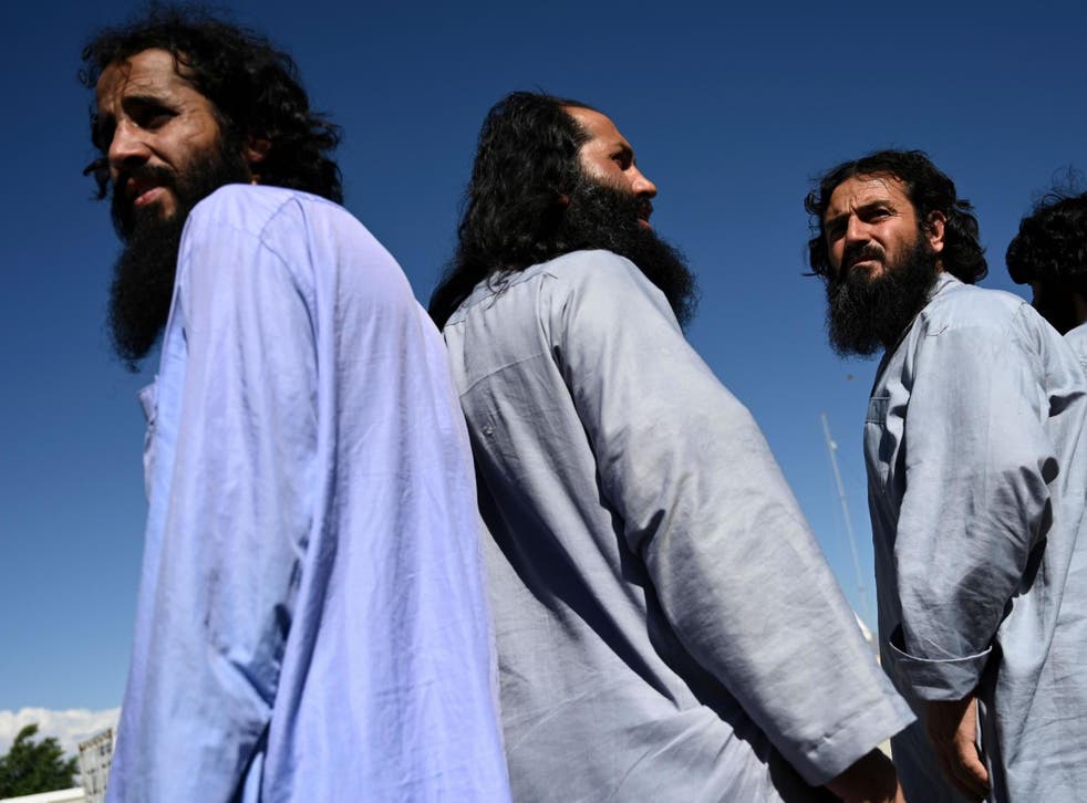 Taliban prisoners stand during their release from the Bagram prison, next to the US military base in Bagram, north of Kabul