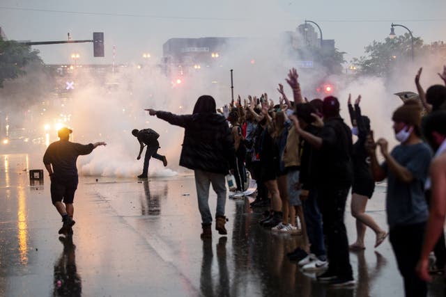Protesters are met with tear gas outside Minneapolis's 3rd Police Precinct