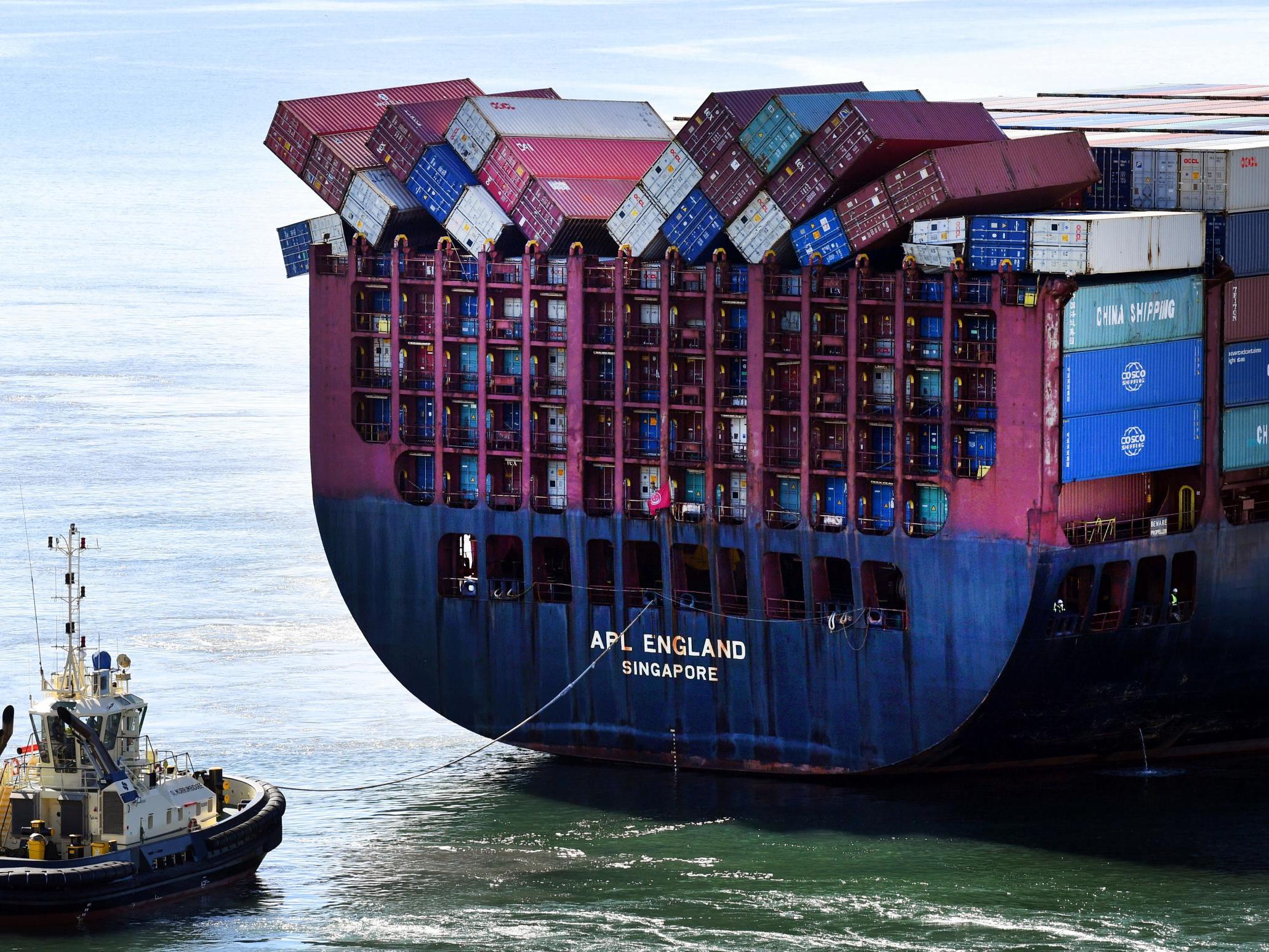 Fallen shipping containers are seen on the container ship APL England as it docks in Brisbane