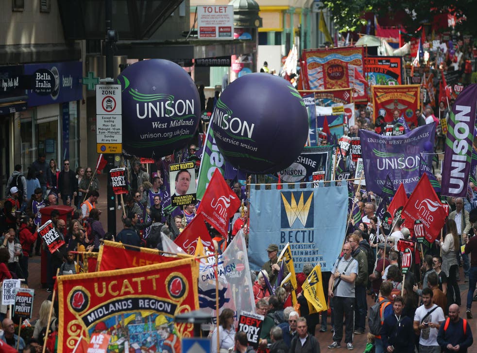 Anti-conservative protesters with placards and trade union banners march through Birmingham during Conservative party annual conference in 2016