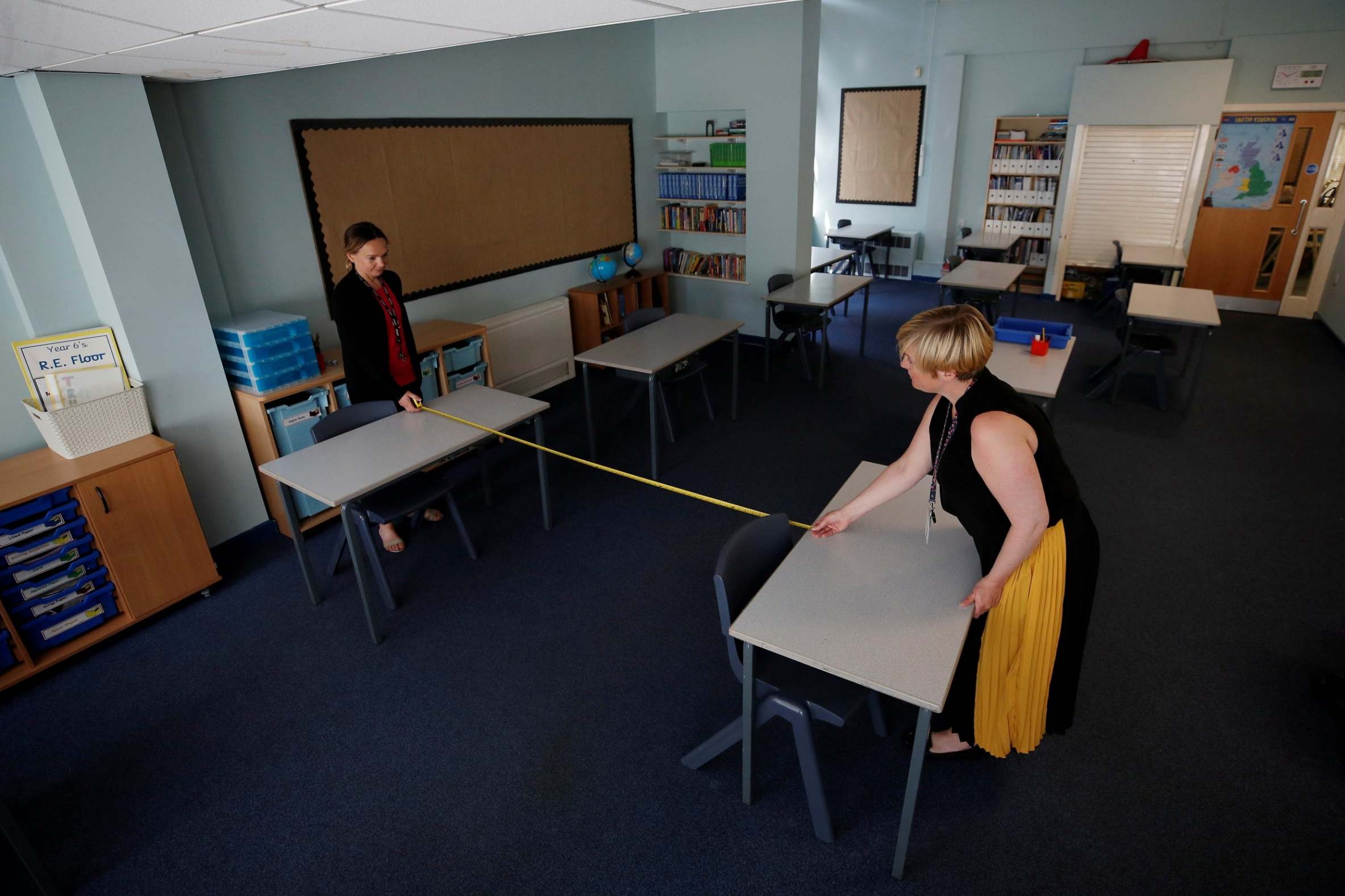 Teachers measure the distance between desks in a classroom in Sale