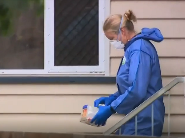 Screengrab of 9 News Australia TV report showing police at a home in Stafford, Brisbane, Australia, where two teenagers were reportedly found locked inside a bedroom after their father died.