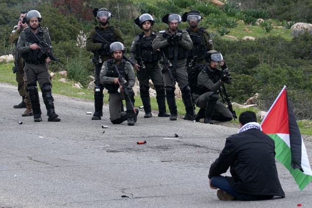 Palestinian protester opposite Israeli forces during clashes over settlements in the Jordan Valley, 25 February 2020