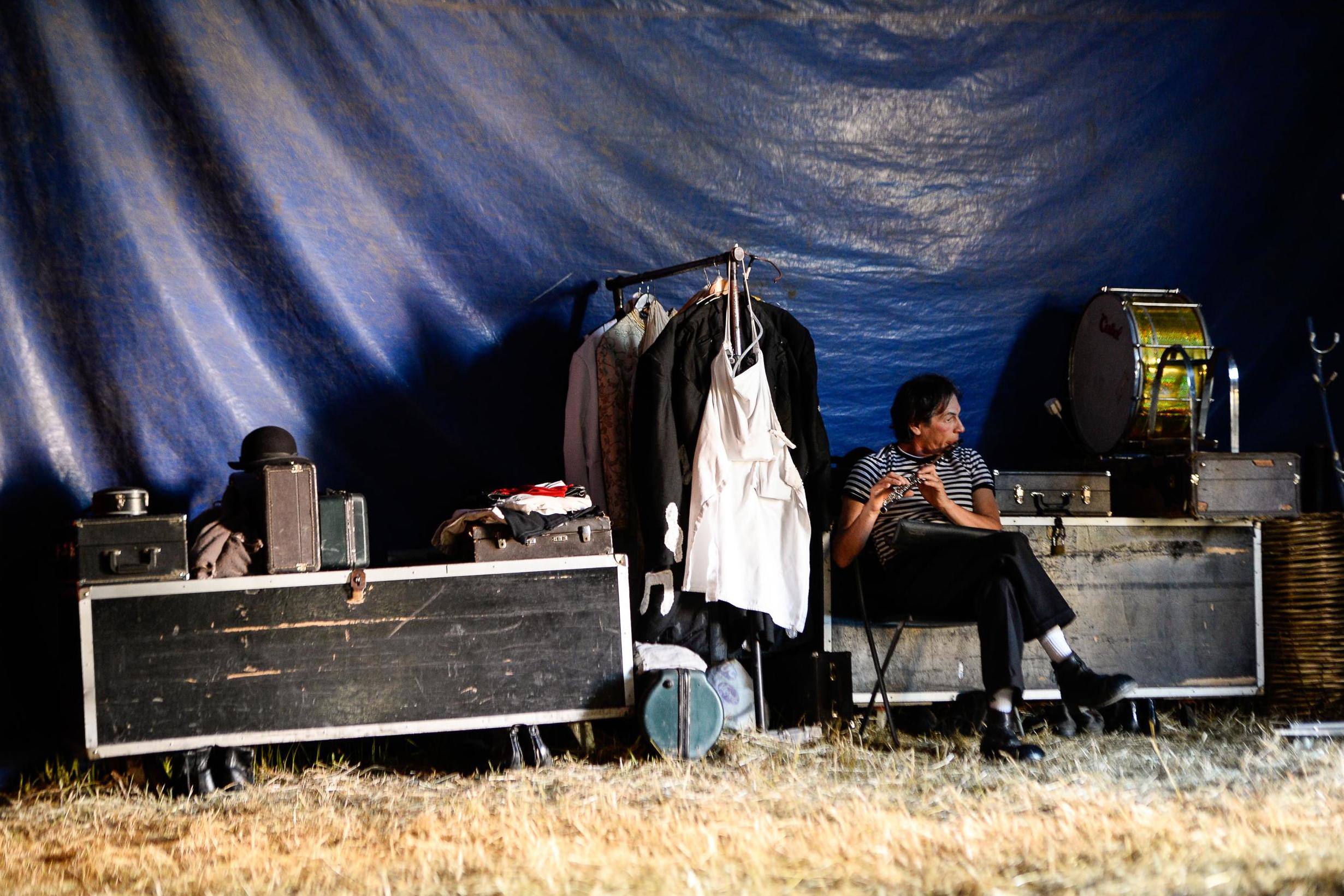 A clown plays an instrument backstage (AFP/Getty)