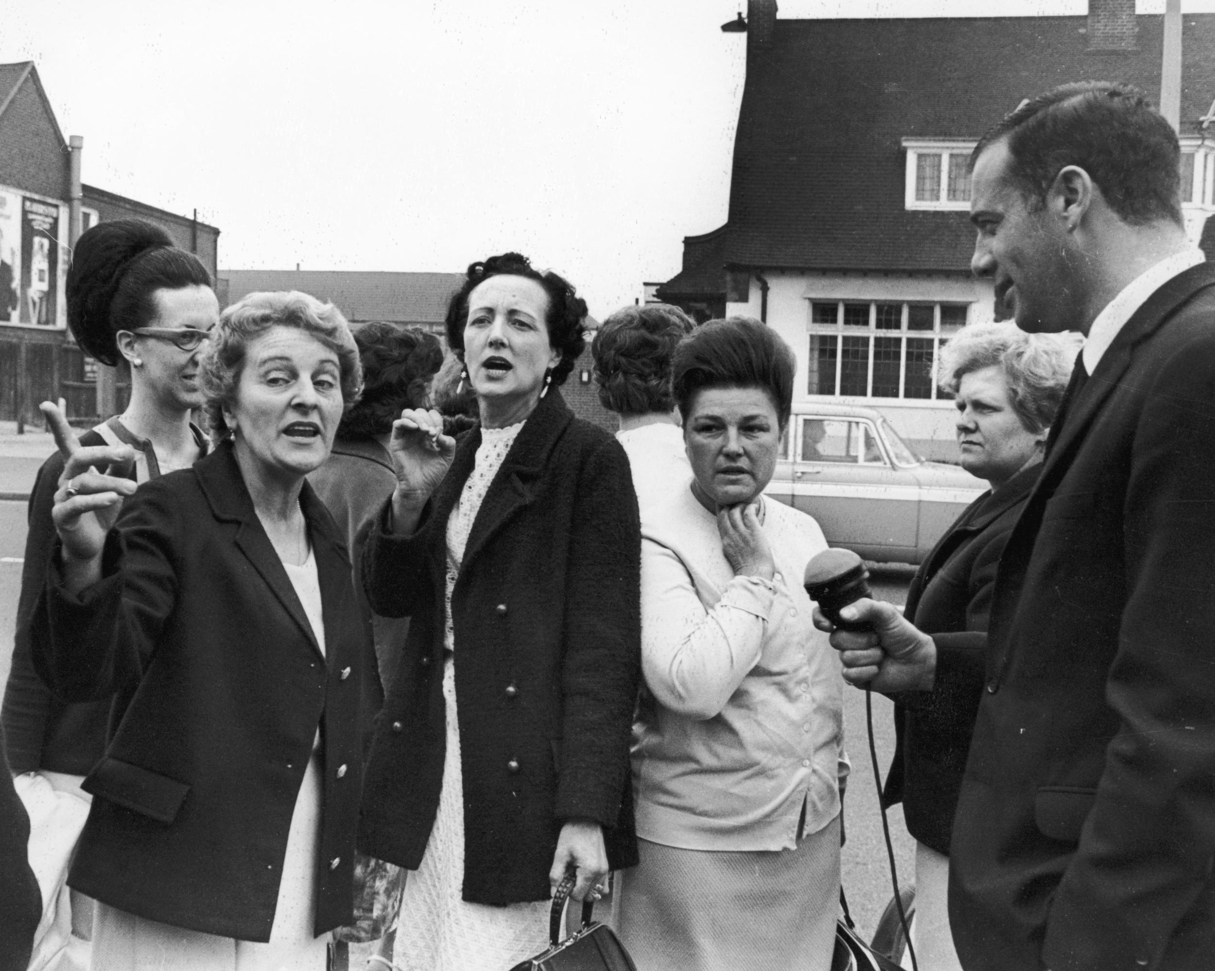 Striking women machinists from the Ford plant at Dagenham are interviewed upon their arrival at Rainham for a meeting with the National Union of Vehicle Builders, 18th June 1968