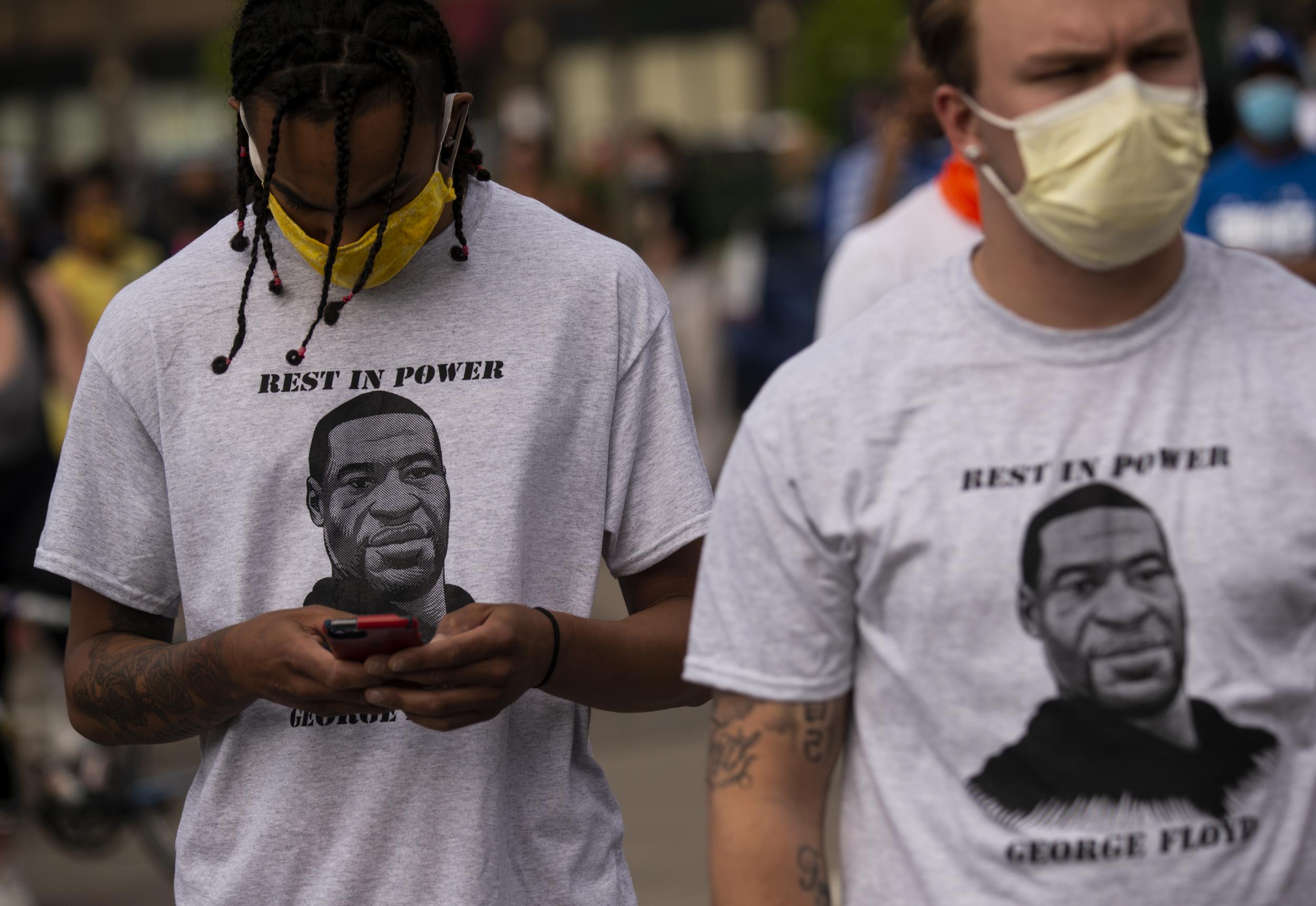 Protestors in Minnesota, wearing face masks and George Floyd T-shirts, march against police brutality
