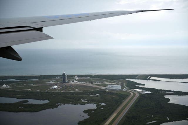 Air Force One flies over Launch pad 39A (L) and the SpaceX facility (R) at Kennedy Space Center in Florida as US President Donald Trump arrives on May 27, 2020