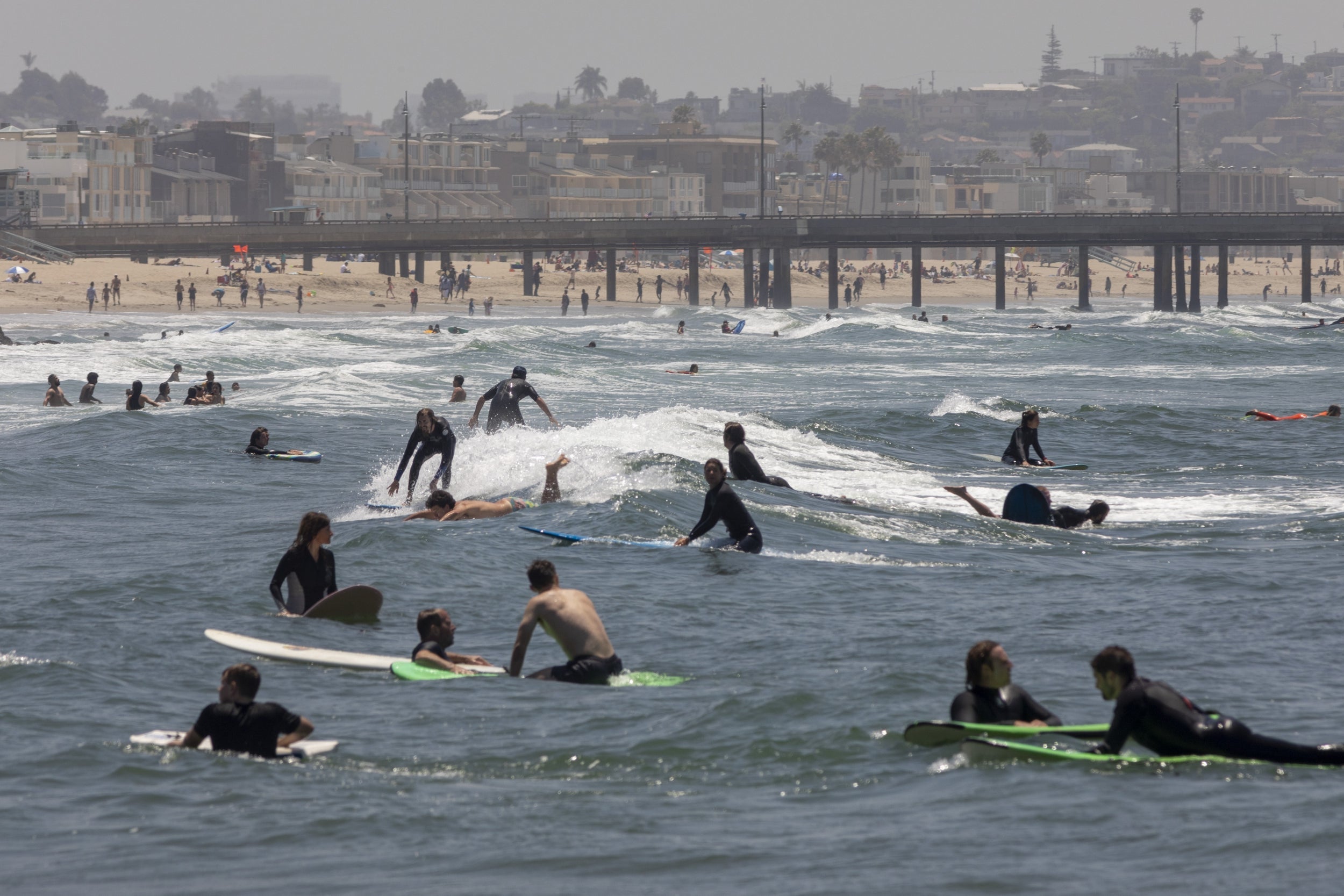 Holiday beachgoers pictured at Venice Beach on Memorial Day as coronavirus safety restrictions continue being relaxed across the state