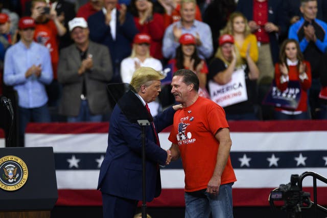 <p>Lt Bob Kroll, head of the Minneapolis police union, shakes hands with Donald Trump during a rally at the Target Center in Minneapolis on 10 October, 2019</p>