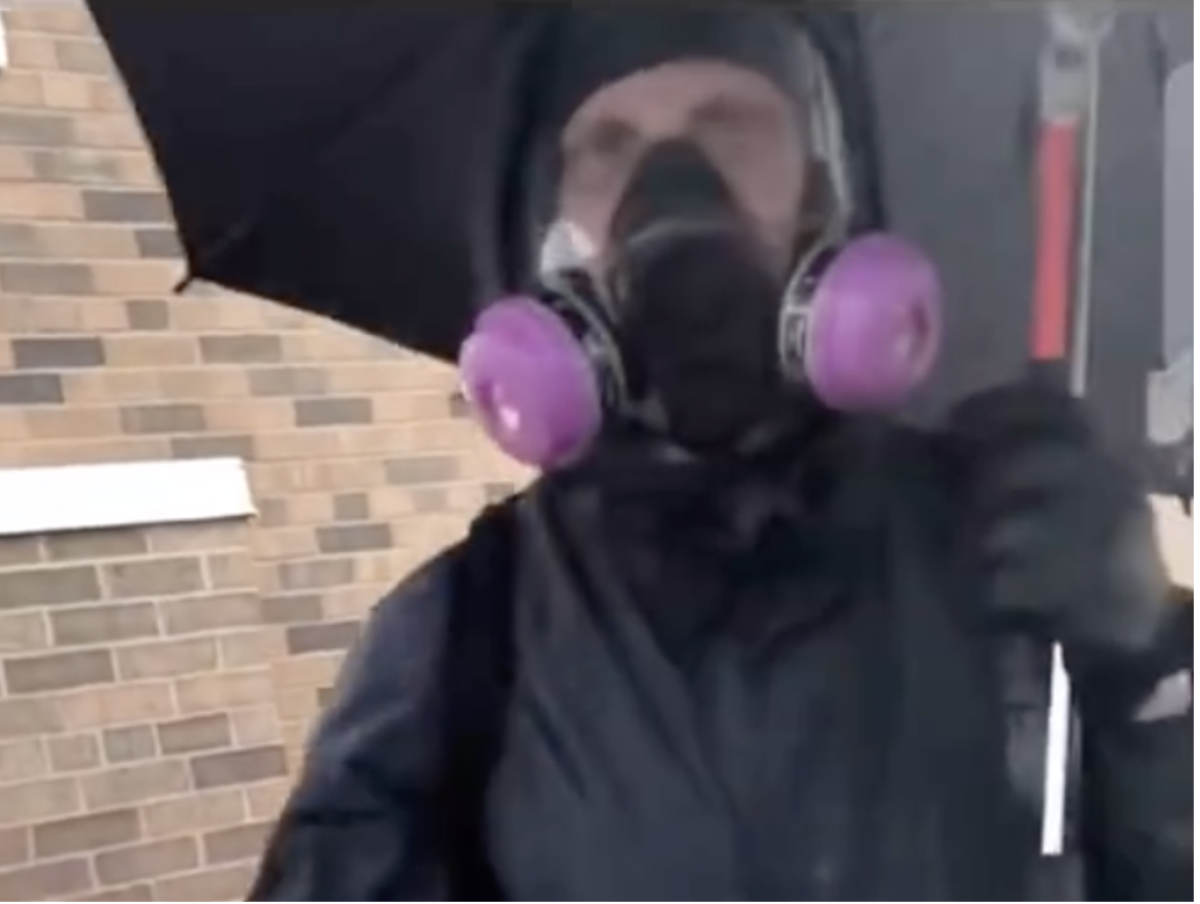 Questions arise over masked white man with umbrella seen calmly smashing windows before Minneapolis riots