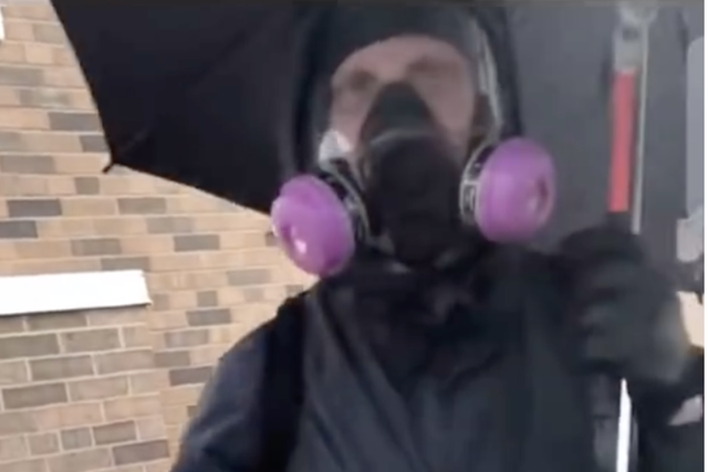 A man dressed in a gas mask and holding an umbrella who was filmed calmly smashing windows. Some have suggested he may have been an agent provocateur