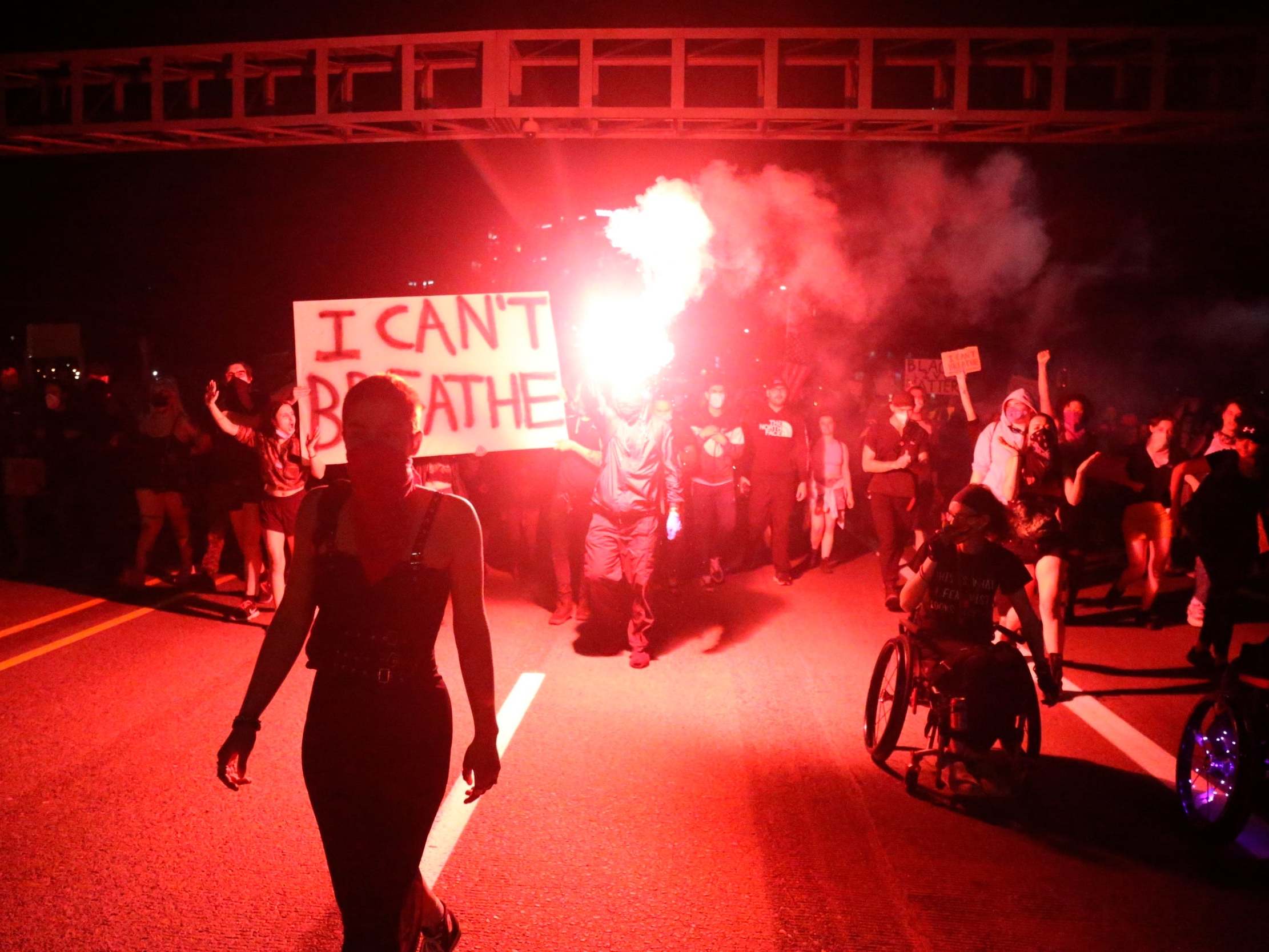 People march from the George Floyd vigil at Peninsula Park towards the Justice Center downtown in Portland, Oregon, on Friday 29 March 2020